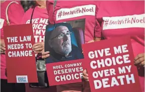  ?? GETTY IMAGES ?? Supporters of Noel Conway, who has motor neuron disease, stand with placards outside Britain’s High Court on July 17.