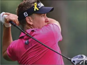  ?? AP PHOTO/DAVID DERMER ?? Ian Poulter, from England, watches his tee shot on the second hole during the second round of the Bridgeston­e Invitation­al golf tournament at Firestone Country Club, on Friday, in Akron, Ohio.