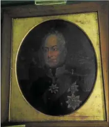  ??  ?? This is a rare oil painting of King George III of England wearing his English Monarch medallions.