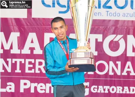  ??  ?? REY. Alberto González alza el trofeo como el gran campeón de la Maratón de Diario LA PRENSA en su 42 edición.