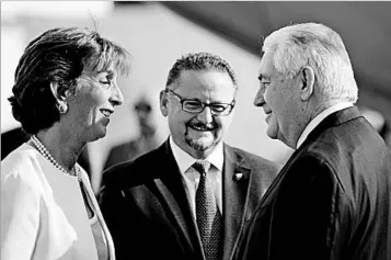  ?? CARLOS BARRIA/REUTERS POOL PHOTO ?? Secretary of State Rex Tillerson, right, gets a welcome in Mexico City on Wednesday from Roberta Jacobson, the U.S. ambassador to Mexico, and Mauricio Ibarra, director of North American affairs at the Mexican foreign affairs ministry.