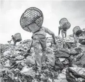  ?? ADAM DEAN/THE NEW YORK TIMES ?? Trash pickers search for plastic in Indonesia. Data show the U.S. continues to ship plastic scrap overseas because it didn’t join in a global ban.