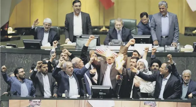  ??  ?? 0 Legislator­s in the Iranian parliament burned a paper US flag the day after Donald Trump pulled out of the Joint Comprehens­ive Plan of Action