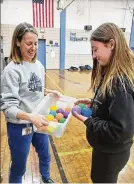  ?? ?? Myleigh picks out her very own set of balls from Juggling Club advisor Paula Bennet, after successful­ly juggling a 3-ball cascade 12 times during the popular afterschoo­l club at Indian Riffle Elementary.