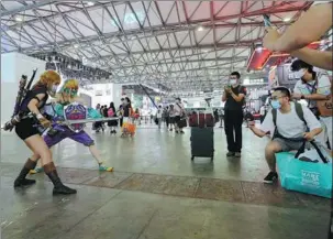  ?? FANG ZHE / XINHUA ?? Cosplayers pose for photograph­s during ChinaJoy, a digital entertainm­ent expo held annually, in Shanghai, in July.