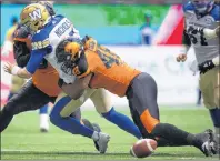  ?? THE CANADIAN PRESS ?? Winnipeg Blue Bombers’ quarterbac­k Matt Nichols, left, drops the ball as he’s hit by B.C. Lions’ Maxx Forde, right, and Mic’hael Brooks, back, during the first half of a CFL football game in Vancouver, B.C., on July 21.