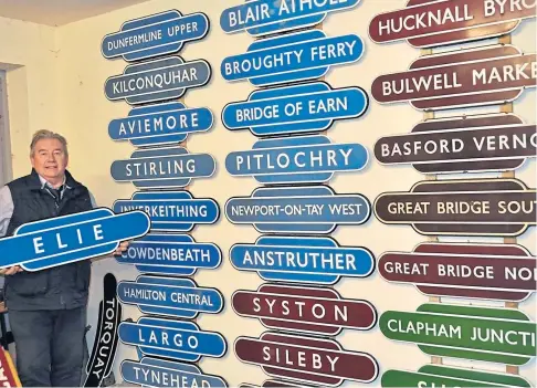  ??  ?? MONEY TRAIN: Auctioneer Neil Booth with some of the historic railway station totems, including the Elie one, which sold for £4,200.