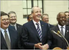  ?? TRENTONIAN FILE PHOTO ?? Phil Murphy(c)is endorsed for Governor of New Jersey by Trenton Mayor Eric Jackson(r)and Mercer County Executive Brian Hughes(l)along with other local Democrats at a press conference outside the state house on Friday.