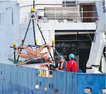  ??  ?? Researcher­s from Ocean Networks Canada deploy an underwater listening station that is used to monitor noise levels experience­d by marine mammals.