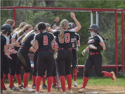  ?? PETE BANNAN/MEDIANEWS GROUP ?? Archbishop Carroll players welcome Christina Jackson home after she launched a 2-run homer against Cardinal O’Hara Thursday.