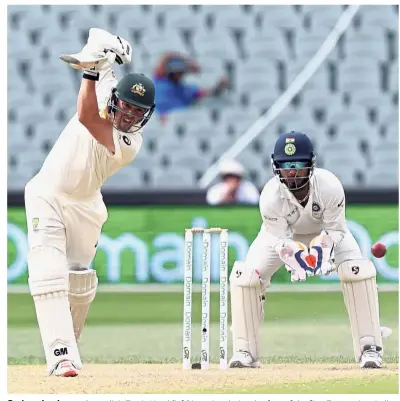  ?? — AP ?? Serious business: Australia’s Travis Head (left) in action during day four of the first Test against India in Adelaide yesterday.