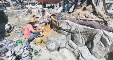  ??  ?? Workers painting the baptismal pond.