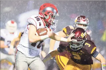  ?? David G. Whitham / For Hearst Connecticu­t Media ?? New Canaan High’s Christian Sweeney tries to make yardage against St. Joseph in the CIAC Class L Semi-final game at Bunnell High School in 2019