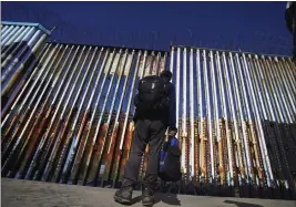  ?? MARCO UGARTE — THE ASSOCIATED PRESS ?? A migrant on the Mexican side of the border in Tijuana. U.S. authoritie­s stopped migrants more than 221,000 times at the Mexican border in March, a 22-year high.