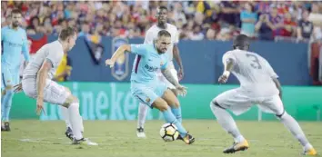  ?? — Reuters ?? Manchester United’s Eric Bailly and Phil Jones in action with Barcelona’s Paco Alcacer.