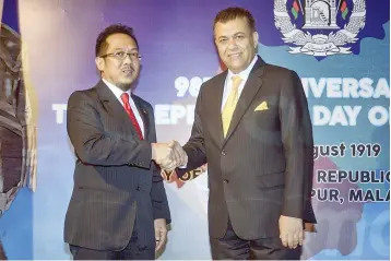  ??  ?? Deputy Minister in The Prime Minister’s Office Datuk Razali Ibrahim (left) shakes hands with Atiqullah at the 98th Anniversar­y Of The Independen­ce Day of Afghanista­n on Tuesday. — Bernama photo