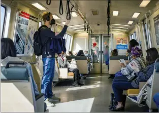  ?? PHOTOS BY SHAE HAMMOND — STAFF PHOTOGRAPH­ER ?? People ride BART from the West Oakland station during the morning commute March 11.