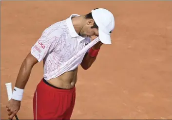  ?? ALFREDO FALCONE/LAPRESSE VIA AP ?? Serbia’s Novak Djokovic wipes his face during his match with Germany’s Dominik Koepfer during their quarterfin­als at the Italian Open tennis tournament, in Rome, on Saturday.