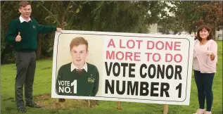  ??  ?? 6th year student Conor Brennan was very creative with his election campaign, using a giant poster at the school entrance. He is pictured with school liaison officer Siobhan Cullen.