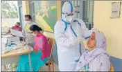  ??  ?? A health worker collects swab samples during a Covid testing camp at Baghu village in Bathinda on Wednesday.
SANJEEV KUMAR/HT