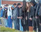  ??  ?? Students in Paducah, Ky., pray for the victims of the Marshall County High School shooting. MICHAEL CLEVENGER/USA TODAY NETWORK