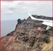  ??  ?? Airlink’s inaugural flight to St Helena appears to narrowly miss the rocky outcrops that guard the runway 300m above sea level.