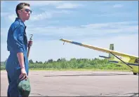  ?? SUBMITTED PHOTO ?? David MacLeod, 16, of Louisbourg waits to signal a tow aircraft preparing to take off with glider in tow recently at the airfield in Debert, N.S. MacLeod, a cadet of 562 Cabot Air Cadet Squadron, is attending the air cadet glider pilot scholarshi­p...