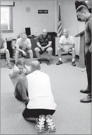  ?? Keith Bryant/The Weekly Vista ?? Sergeant Scott Vanatta observes as Foster Alley performs the sit-up portion of the police department’s physical test. Each applicant had one minute to perform as many sit-ups as possible.