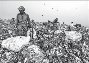  ?? SAUMYA KHANDELWAL/NEW YORK TIMES ?? People separate waste at the Bhalswa landfill May 6 in New Delhi, India. On top of polluted air and water, India’s capital is being forced to reckon with rising trash dumps so dangerous that they are killing people.