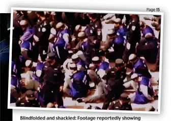  ??  ?? Blindfolde­d and shackled: Footage reportedly showing Uyghur Muslims being detained by the Chinese police force