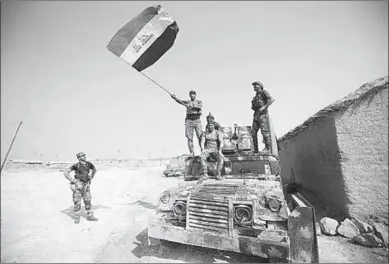  ??  ?? Iraqi forces deploy in the Bajwaniyah village, about 30 kms south of Mosul, on October 18, 2016 after they liberated it from IISIS group jihadists.