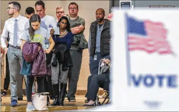  ?? JOHN SPINK/JSPINK@AJC.COM ?? Voters waited more than an hour to vote Tuesday at Henry W. Grady High School in Atlanta. Two congressio­nal races in the city’s northern suburbs were seen as bellwether­s for President Donald Trump’s popularity.