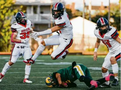  ?? WINSLOW TOWNSON FOR THE GLOBE ?? Quinn Rocco Ryan hurdled Lynn Classical as one of six Witches to find the end zone in a back-and-forth Friday the 13th victory that kept Salem among the ranks of the unbeaten.