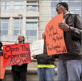  ?? Arkansas Democrat-Gazette/MITCHELL PE MASILUN ?? Toney Orr of Little Rock leads chants Friday as people protest the government shutdown outside the Victory building, which houses the Little Rock offices of U.S. Sens. Tom Cotton and John Boozman in Little Rock.