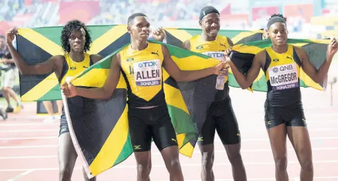  ?? GLADSTONE TAYLOR/MULTIMEDIA PHOTO EDITOR ?? From left: Tiffany James, Nathon Allen, Javon Francis and Roneisha McGregor celebrate their silver medal in the 4x400m mixed relay at the 2019 IAAF World Athletics Championsh­ips in Doha, Qatar, yesterday.