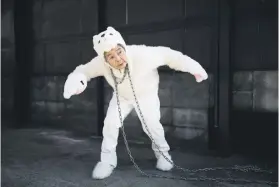  ??  ?? HOOKED. Kimiko Nishimoto, dressed in a dog costume, gestures during a self-photoshoot.