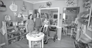  ?? STAFF PHOTOS BY DARWIN WEIGEL ?? Sandy Moreland, left, and her daughter Stacy Moreland, center, pose for picture with Stacy’s daughter Sydney Terrell and her 11-monthold baby Asher, in The Little Corner Shoppe in La Plata.