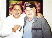  ?? CONTRIBUTE­D ?? Dr. Harvey Garber (left) stands with patient Walter Goldberg in December 2010. Garber is seeking an unspecifie­d amount of damages from Boynton Beach and four officers.