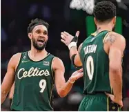  ?? Steven Senne/Associated Press ?? Celtics guard Derrick White (9) celebrates with Jayson Tatum in the second half against the Grizzlies on Sunday.