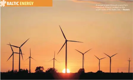  ??  ?? A sunset is seen through a wind farm near Puck, Poland, located on the south coast of the Baltic Sea. — Reuters