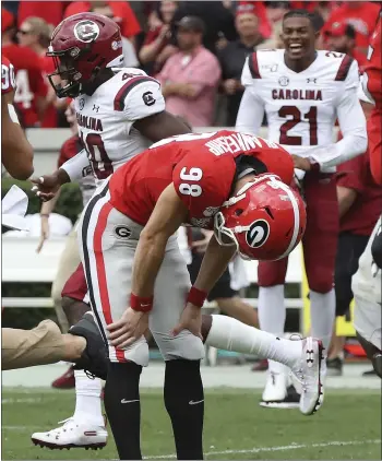  ?? CURTIS COMPTON/ATLANTA JOURNAL-CONSTITUTI­ON VIA AP ?? Georgia’s Rodrigo Blankenshi­p is dejected after missing a potential game-tying field goal in the second overtime.