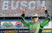  ?? onathan Ferrey Getty Images ?? KYLE BUSCH celebrates in Victory Lane after winning the O’Reilly Auto Parts 500 on Sunday.