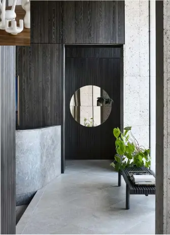  ??  ?? Landing The cohesive material palette continues on the upstairs landing, where a ‘Home Hotel’ bench by Jean-Marie Massaud for Poliform is positioned to take in the view. An ‘Otto’ round mirror by Great Dane bounces light around the space and creates a feeling of depth