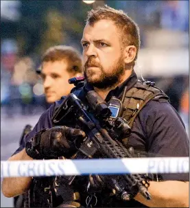  ?? AP/VICTORIA JONES ?? Police officers in London’s Finsbury Park guard the cordoned area where a vehicle plowed into pedestrian­s earlier Monday.