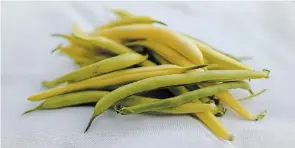  ??  ?? Yellow wax beans taste best when they are freshly picked, quickly cooked in boiling water and topped with a pat of butter and grindings of salt and pepper.