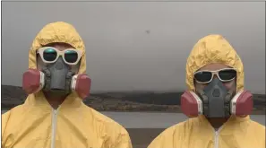  ??  ?? Ray and Paul Holmberg’s music video for their pandemic-inspired song “When This Ends” features them in hazmat suits.