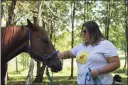  ?? Contribute­d photo ?? Radiation therapist Catherine Goodyear pets a horse.