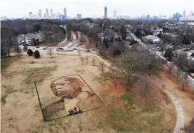 ?? AP PHOTO/ANGIE WANG ?? A portrait of John Lewis, the longtime congressma­n and civil rights leader, is seen in this aerial view Thursday at Freedom Park in Atlanta. Artist Stan Herd created this earthworks piece in recognitio­n of John Lewis’ life and work.