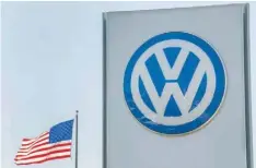  ??  ?? An American flag flies next to a Volkswagen car dealership in San Diego, California.