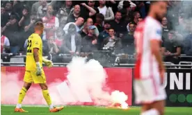  ?? Photograph: Olaf Kraak/EPA ?? The flares thrown on to the pitch at the Johan Cruyff Arena forced the game to be halted